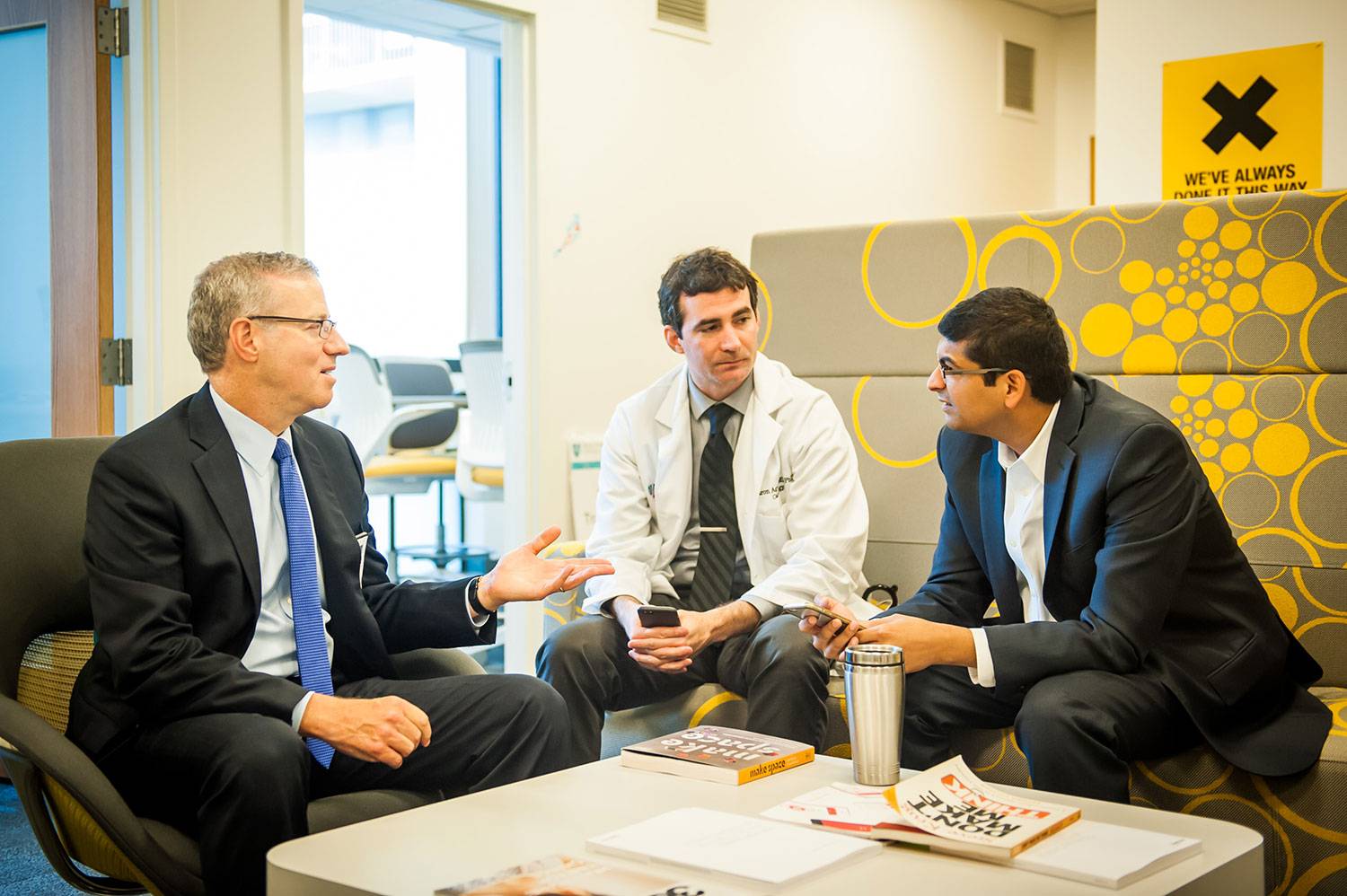 Dartmouth Master of Health Care Delivery Science program graduate with colleagues