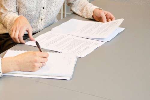 Two people looking at a resume